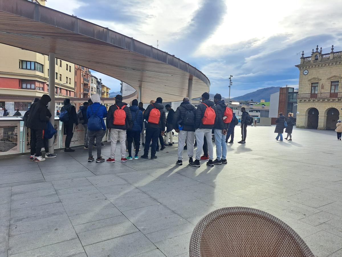 Un grupo de migrantes en la plaza del Ayuntamiento de Irún.