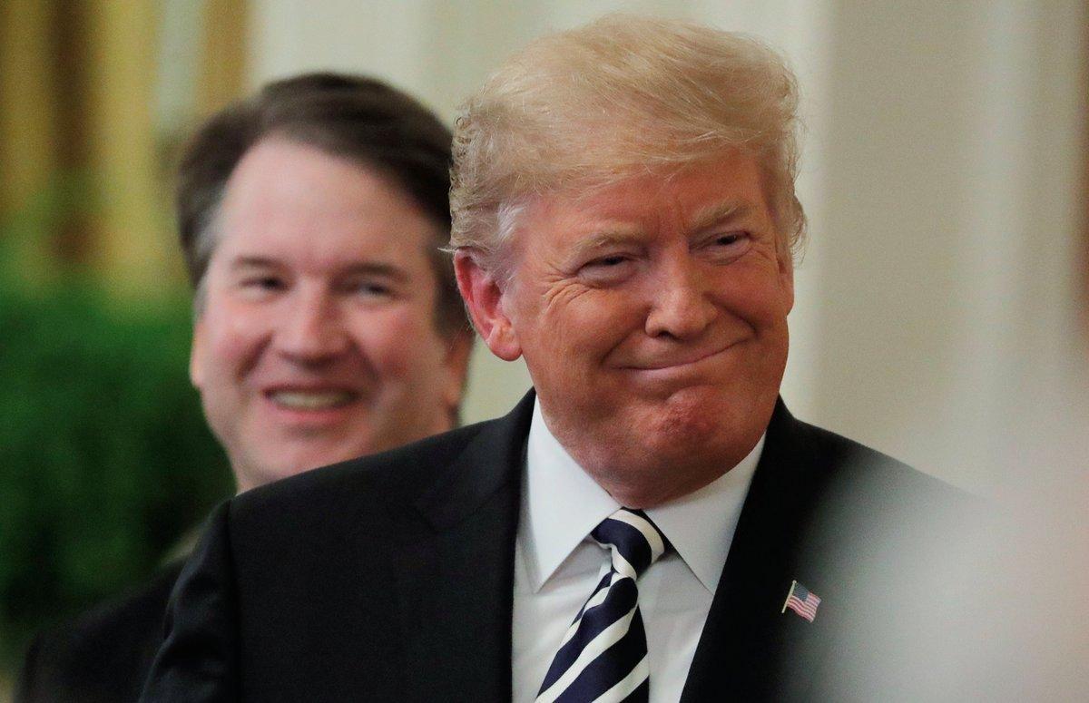 U S  President Donald Trump smiles next to U S  Supreme Court Associate Justice Brett Kavanaugh as they participate in a ceremonial public swearing-in in the East Room of the White House in Washington  U S   October 8  2018     REUTERS Jim Bourg
