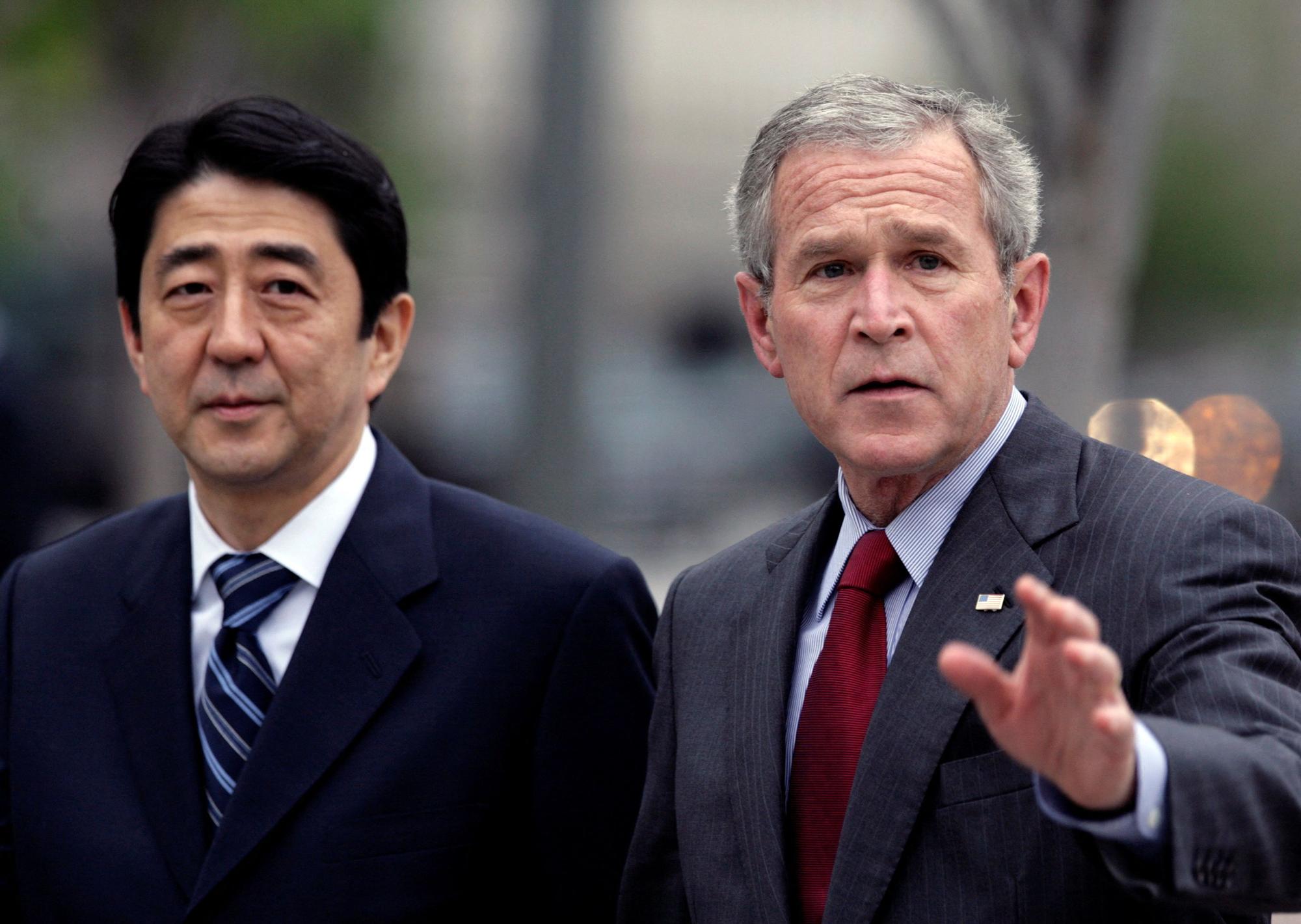 FILE PHOTO: U.S. President Bush waves as he walks with Japan's PM Abe to the White House