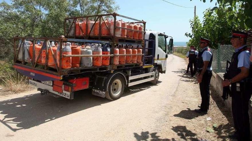 Un camión retirada parte de las más de cien bombonas que se acumulaban en la casa de Alcanar. // Efe