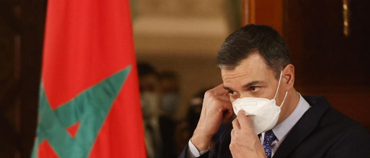 Pedro Sánchez junto a una bandera de Marruecos en su reciente visita institucional a Rabat.