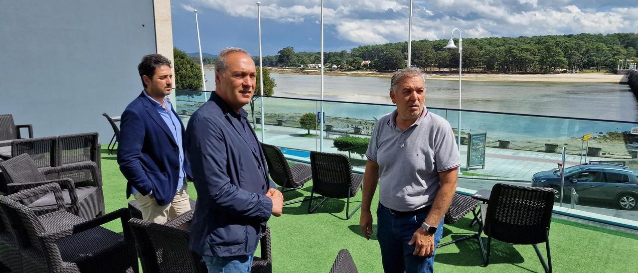 Una terraza con vistas a la ría y A Toxa, en el hotel Puente de La Toja, regentado por Jaime Devesa, que aparece a la derecha de la foto, junto a Pablo Leiva y Agustín Reguera. | // FDV