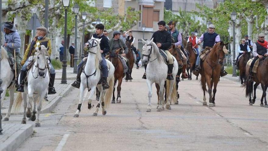 El grupo de jinetes a su paso por la travesía de El Puente.