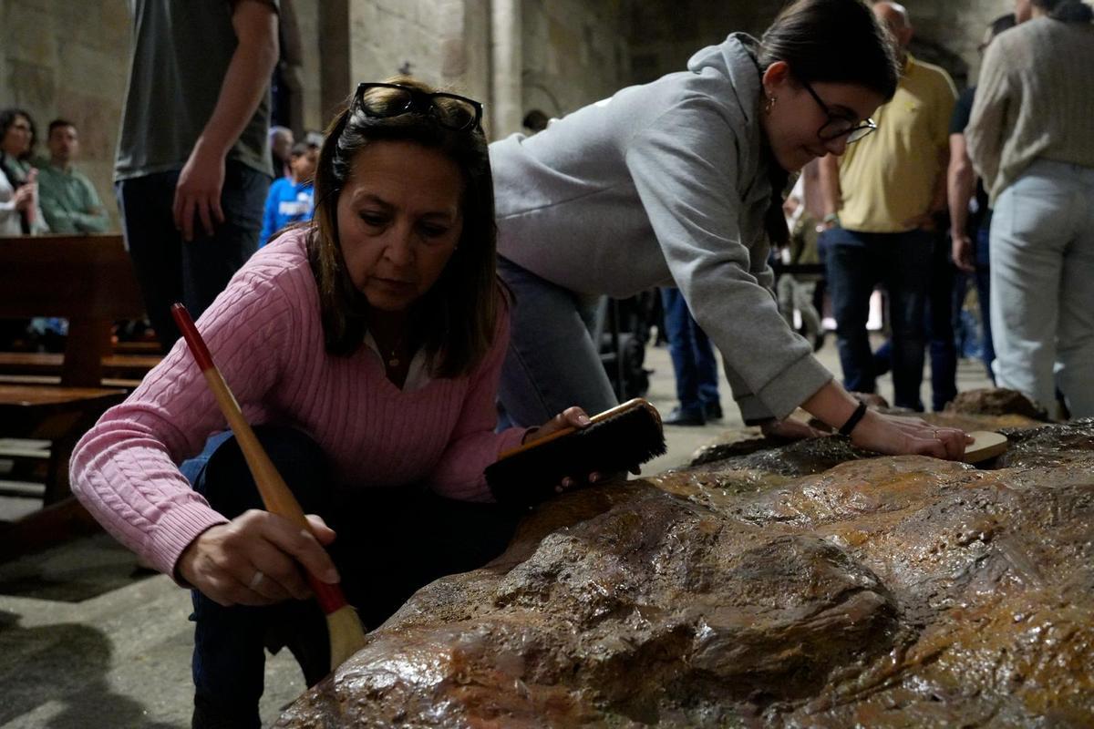 GALERÍA | Los hermanos de las Siete Palabras preparan el Cristo de la Agonía para la procesión del Martes Santo