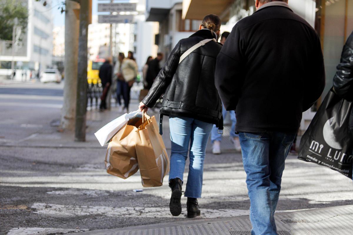 Una mujer con bolsas de tiendas.