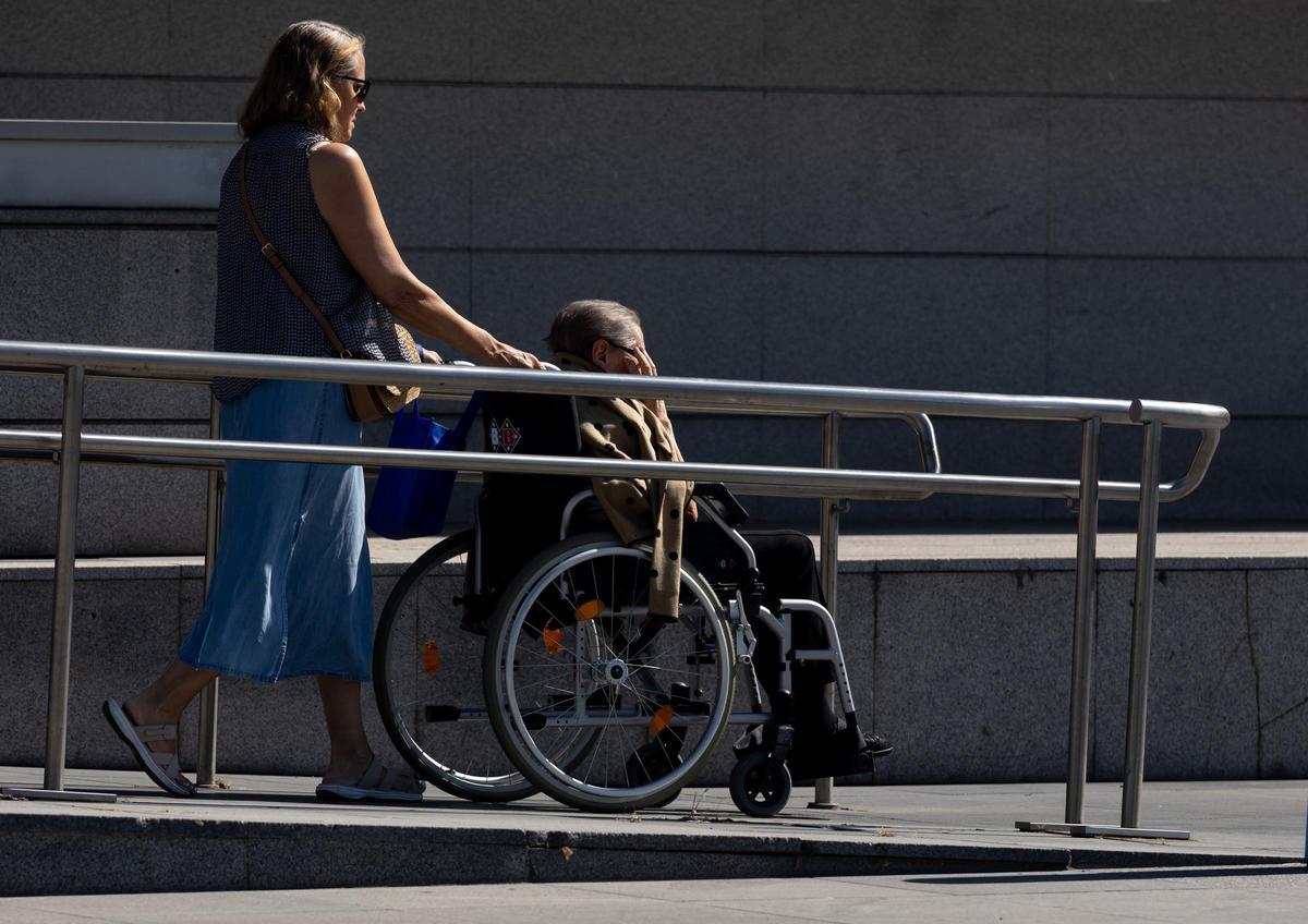 Una persona con discapacidad trasladada en silla de ruedas