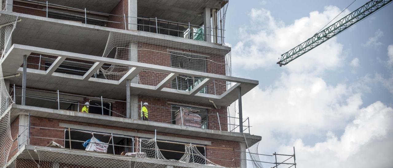 Operarios trabajando en un edificio en construcción en Alicante.