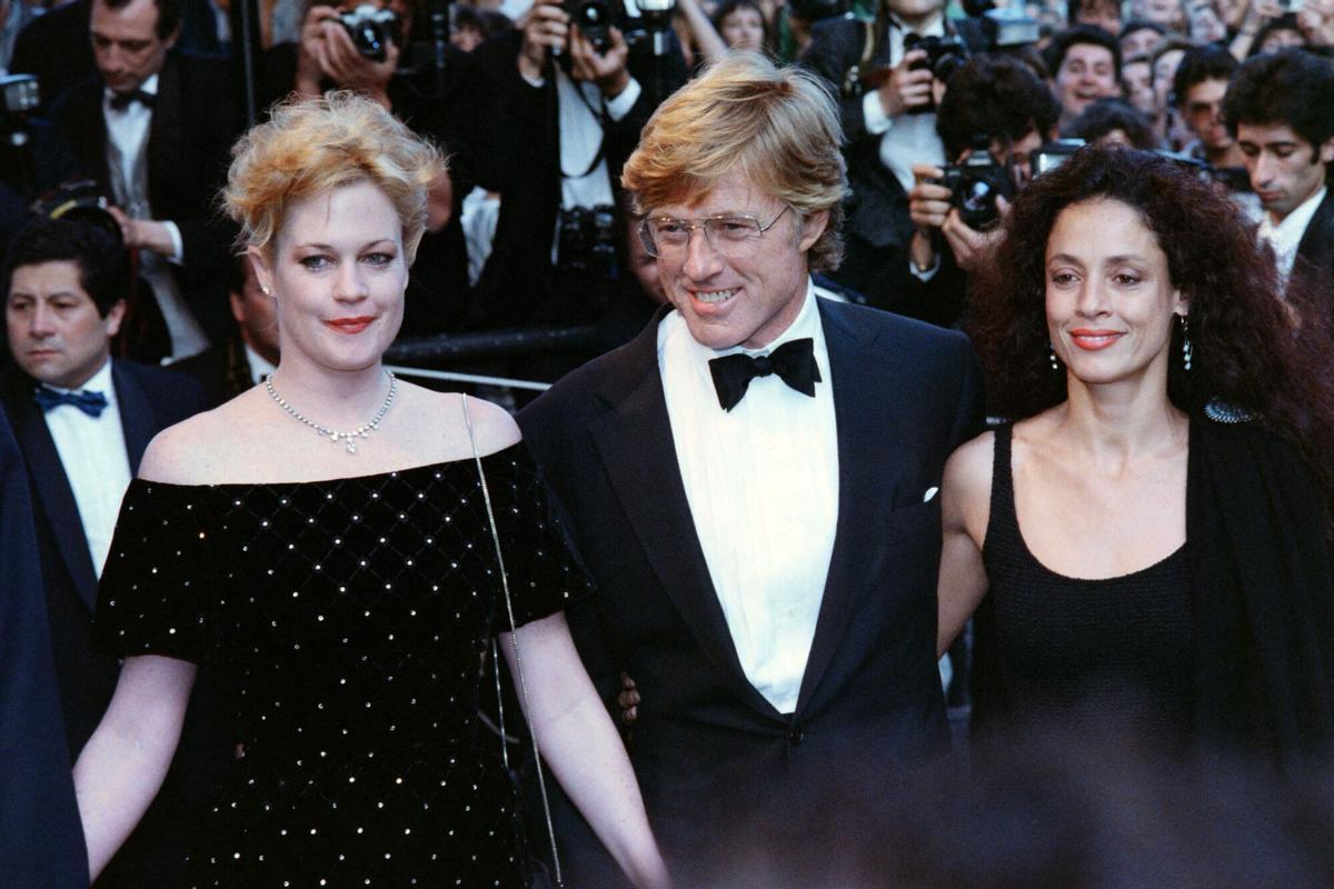 (FILES) (From L to R), American actress Melanie Griffith, American actor and director Robert Redford, and Brazilian actress Sônia Braga during the Tapis Rouge, for the movie "The Milagro Beanfield War" at the 41th edition of the Cannes Film Festival in Cannes, southern France on May 15, 1988. US acting legend Robert Redford died early on September 16, 2025, at his home in Utah, the New York Times reported. He was 89. (Photo by AFP PHOTO / AFP)