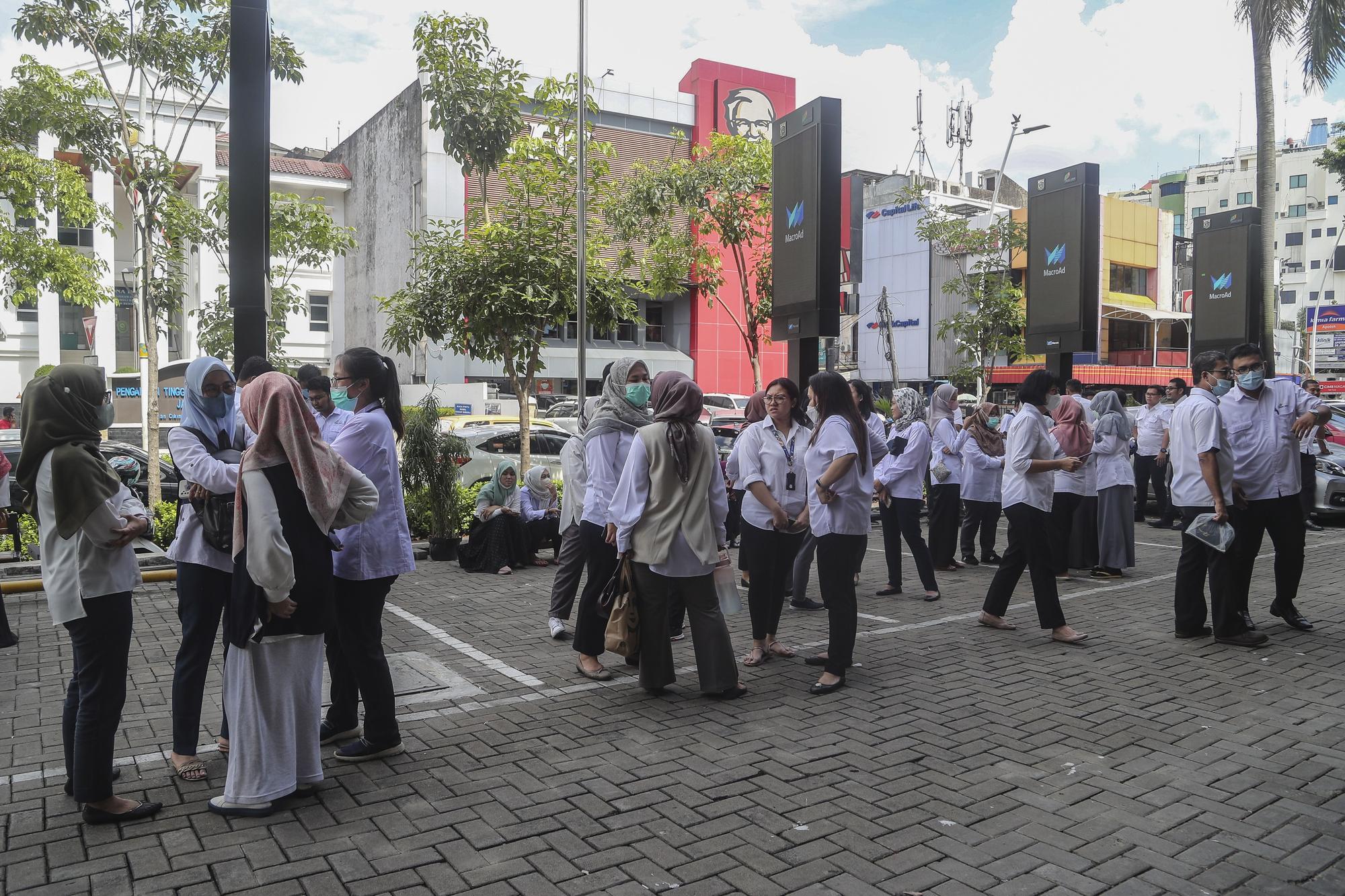 People stay outside after a 5.6 magnitude earthquake shakes West Java