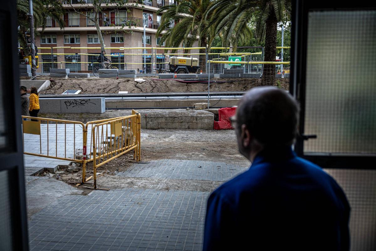 Daniel Plana observa las obras del tranvía desde la puerta de su taller, en Barcelona.
