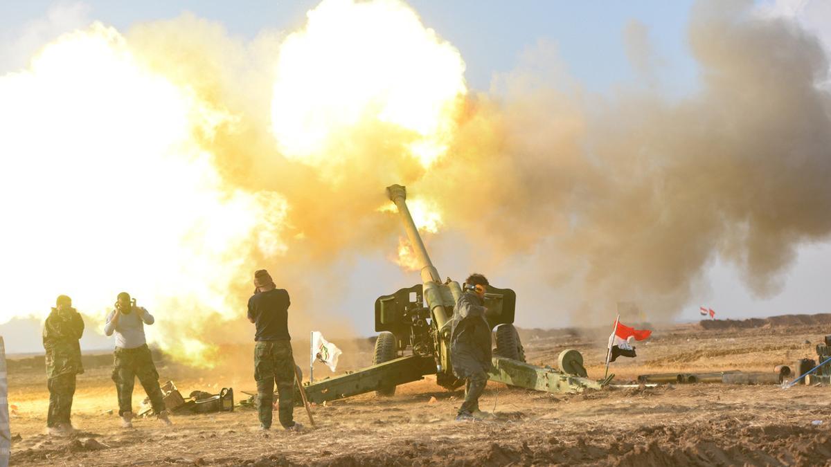 Members of Hashid Shaabi or Popular Mobilization Forces (PMF) fire towards Islamic State militant positions in west of Mosul