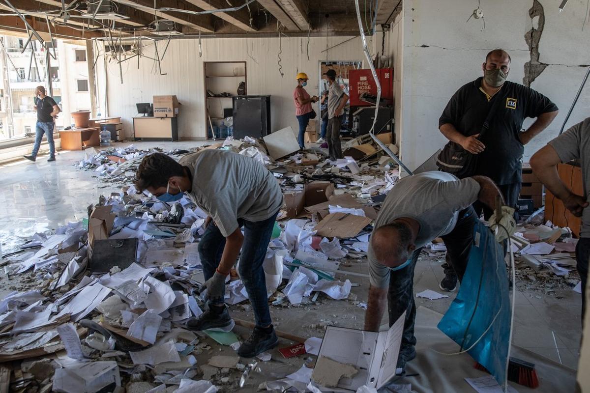 BEIRUT, LEBANON - AUGUST 17: Employees clear rubble inside the destroyed Lebanon Electricity Company (EDL) building on August 17, 2020 in Beirut, Lebanon. The explosion at Beirut’s port killed over 200 people, injured thousands, and upended countless lives. There has been little visible support from government agencies to help residents clear debris and help the displaced, although scores of volunteers from around Lebanon have descended on the city to help clean. (Photo by Chris McGrath/Getty Images) BEIRUT, LEBANON - AUGUST 17: Employees clear rubble inside the destroyed Lebanon Electricity Company (EDL) building on August 17, 2020 in Beirut, Lebanon. The explosion at Beirut’s port killed over 200 people, injured thousands, and upended countless lives. There has been little visible support from government agencies to help residents clear debris and help the displaced, although scores of volunteers from around Lebanon have descended on the city to help clean. (Photo by Chris McGrath/Getty Images)