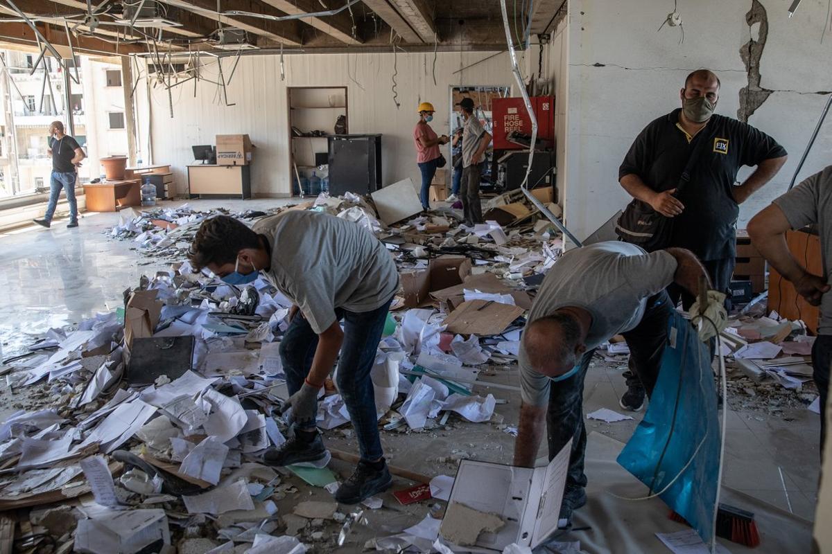 BEIRUT, LEBANON - AUGUST 17: Employees clear rubble inside the destroyed Lebanon Electricity Company (EDL) building on August 17, 2020 in Beirut, Lebanon. The explosion at Beirut’s port killed over 200 people, injured thousands, and upended countless lives. There has been little visible support from government agencies to help residents clear debris and help the displaced, although scores of volunteers from around Lebanon have descended on the city to help clean. (Photo by Chris McGrath/Getty Images)