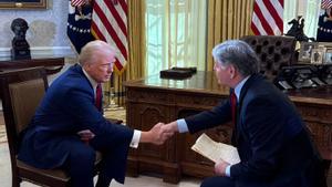 Donald Trump estrecha la mano de Sean Hannity en su primera entrevista tras asumir el cargo.