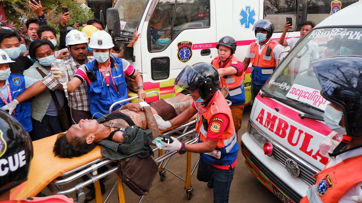 An injured man is carried by rescue workers after protests against the military coup, in Mandalay, Myanmar, February 20, 2021. REUTERS/Stringer  NO RESALES. NO ARCHIVES.