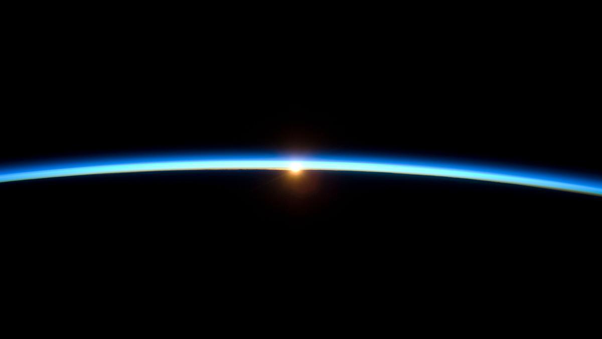 La delgada atmósfera de la Tierra al atardecer, con la silueta de la Tierra.