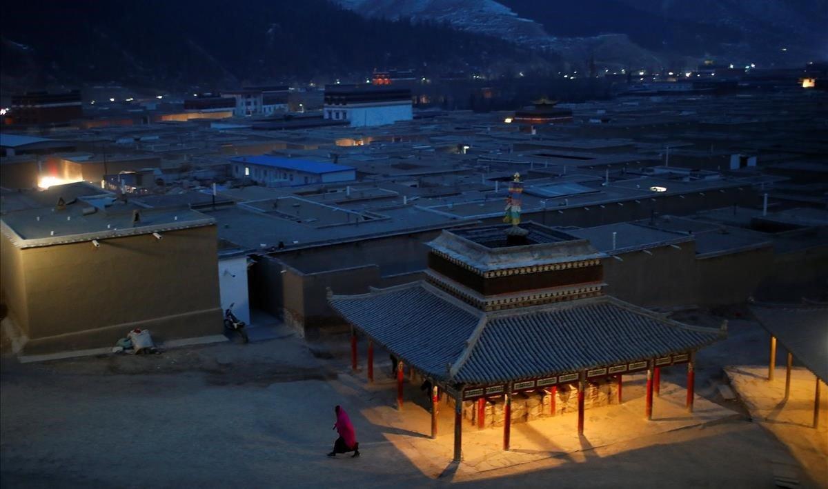 Un monje tibetano camina por un callejón en el monasterio de Labrang antes del festival Sunbathing Buddha en el condado de Xiahe, provincia de Gansu, China