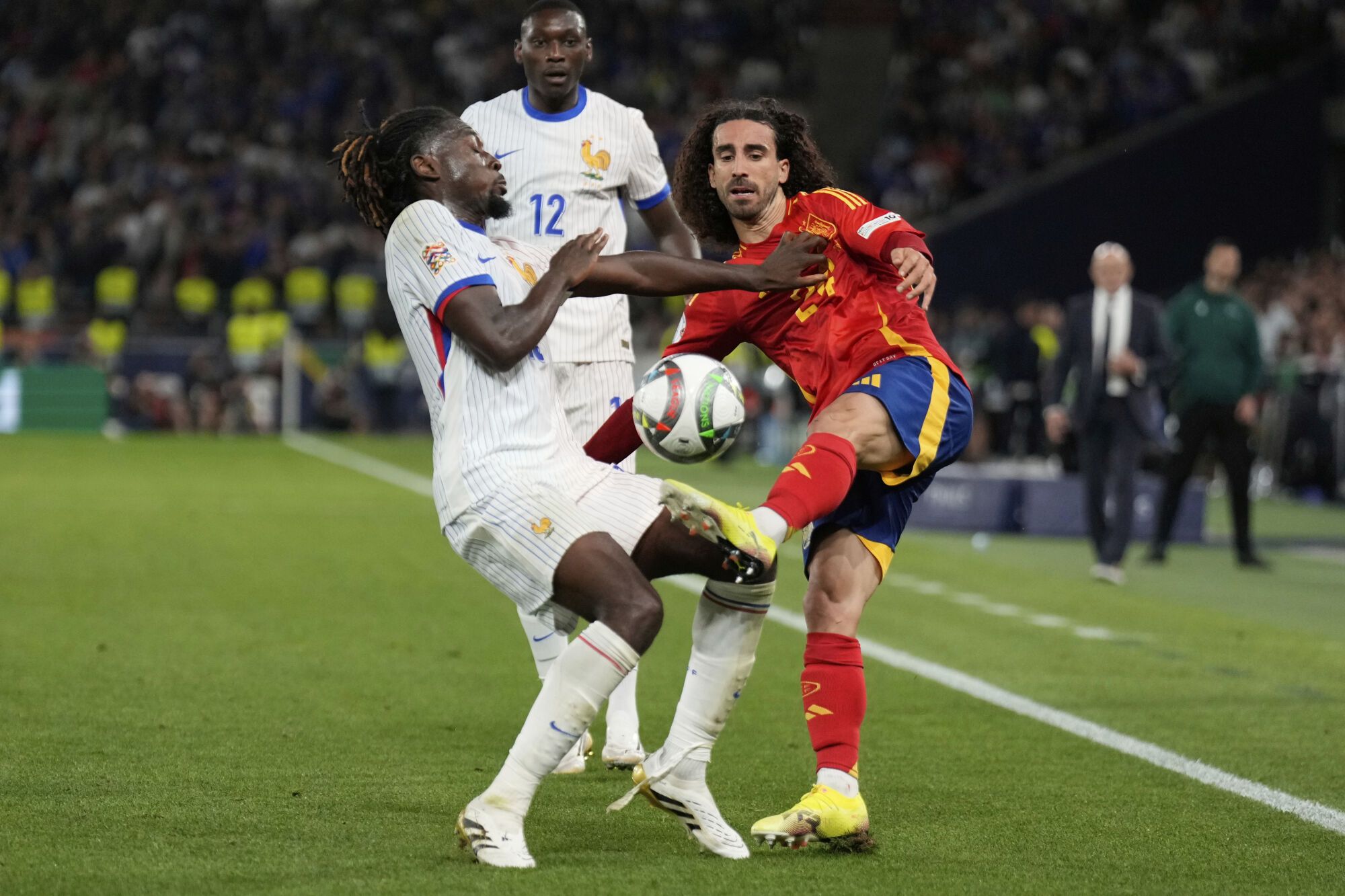 France's Manu Kone, left, and Spain's Marc Cucurella fight for the ball during the Nations League semifinal soccer match between Spain and France in Stuttgart, Germany, Thursday, June 5, 2025. (AP Photo/Matthias Schrader)