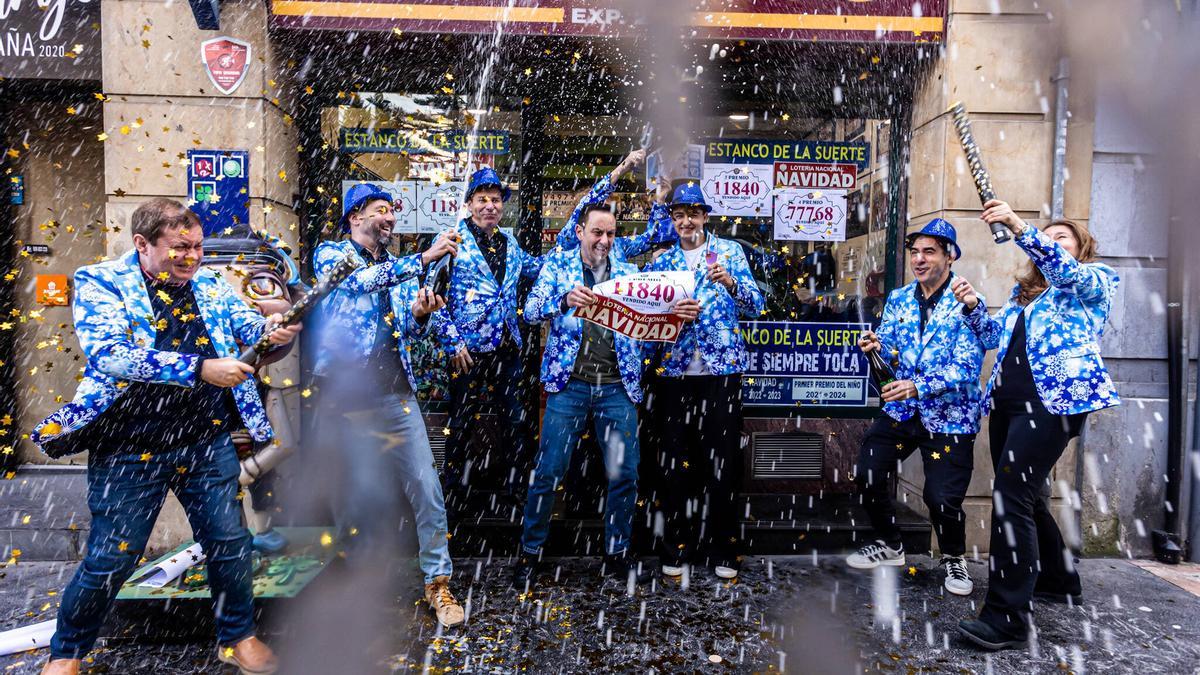 Miembros de la familia Acebal celebran un tercer premio de la Lotería de Navidad vendido en la administración que regentan en Oviedo.