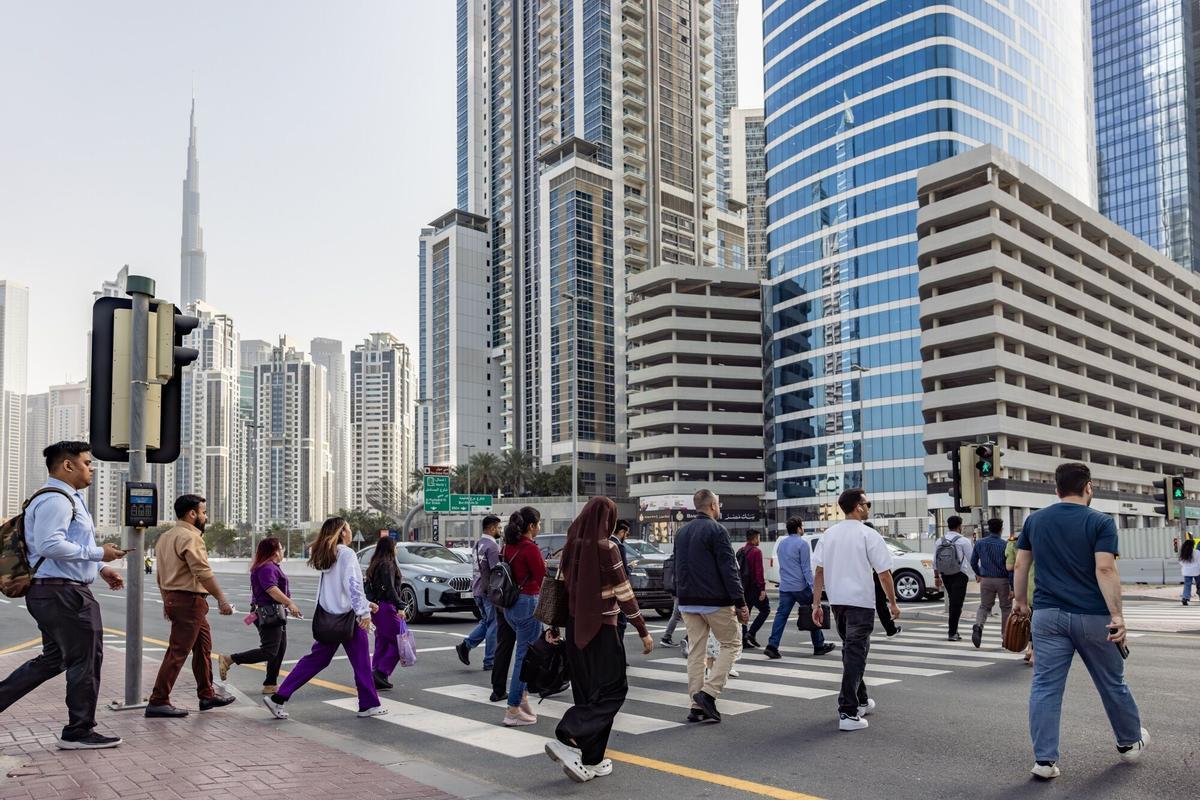 Pedestrians cross a road in the Business Bay financial district of Dubai, United Arab Emirates, on Wednesday, March 4, 2026. The US State Department urged Americans to leave the Middle East, citing “serious safety risks” amid dangers from the war. Photographer: Walaa Alshaer/Bloomberg