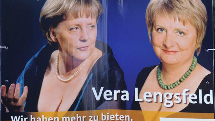 Cartel electoral con la canciller alemana, Angela Merkel (i), y la candidata de la Unión Cristianodemócrata Alemana (CDU) Vera Lengsfeld, ambas con un pronunciado escote, y con el eslogan &quot;Nosotros tenemos más que ofrecer&quot;, en el barrio berlinés de Kreuzberg (Alemania)