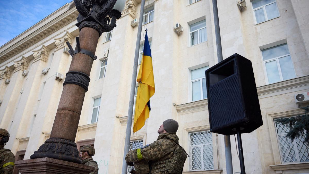 Ukrainian serviceman takes part in a national flag raising ceremony in Kherson