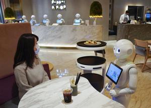 Tokyo (Japan), 05/11/2020.- A robot takes a food order from a customer at Pepper PARLOR, where robots are working with human staff, in Tokyo, Japan, 05 November 2020 (issued 11 November 2020). Catering, delivery and transportation Service Robots were developed by SoftBank Robotics Corp. for the purpose of working with employees at restaurants, hotels and retail stores. The robots were introduced to reduce direct contacts between staff and customers amid the ongoing Covid-19 pandemic. (Japón, Tokio) EFE/EPA/KIMIMASA MAYAMA