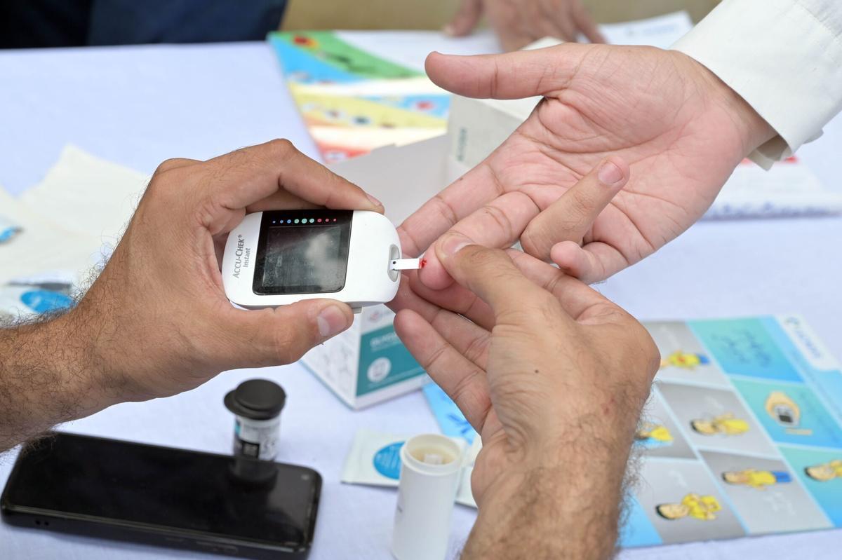 Imagen de archivo de un sanitario haciendo una prueba de glucosa en sangre.