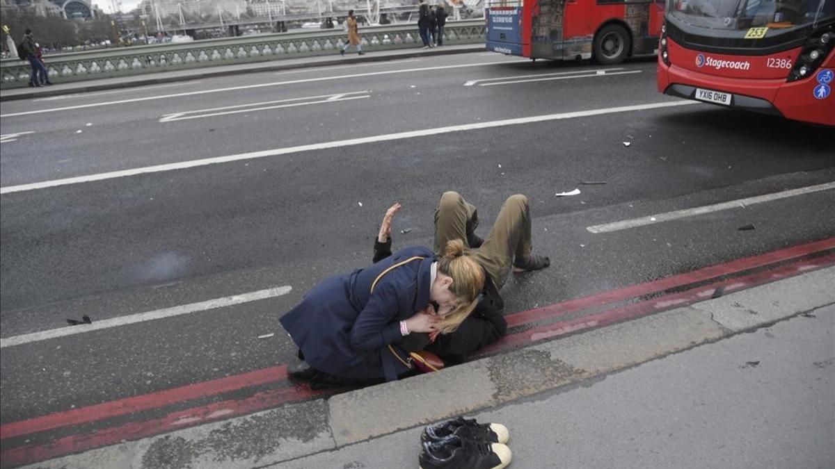 Una mujer asiste a un herido en el puente de Londres