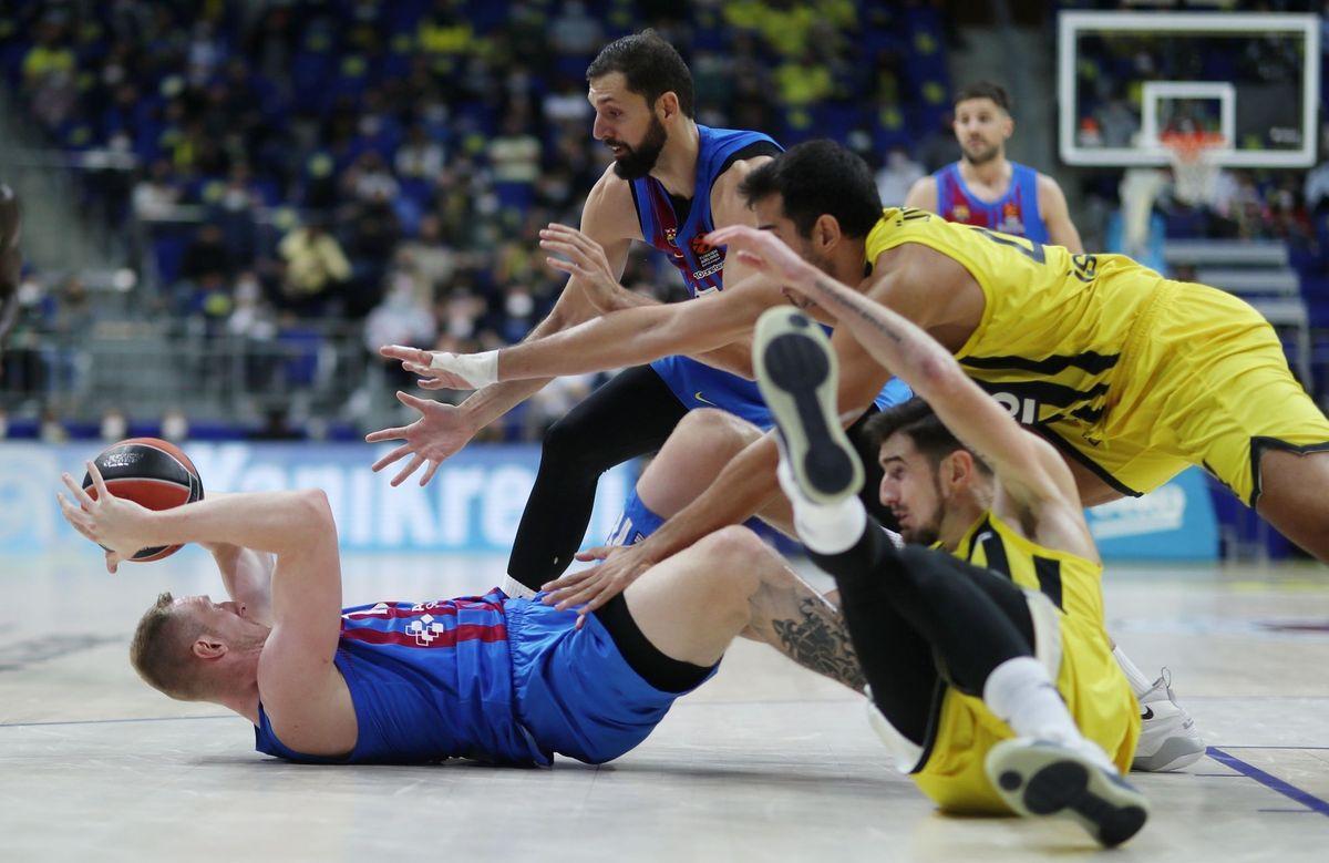 El azulgrana Roland Smits controla un balón en el suelo, presionado por dos jugadores del Fenerbahçe.