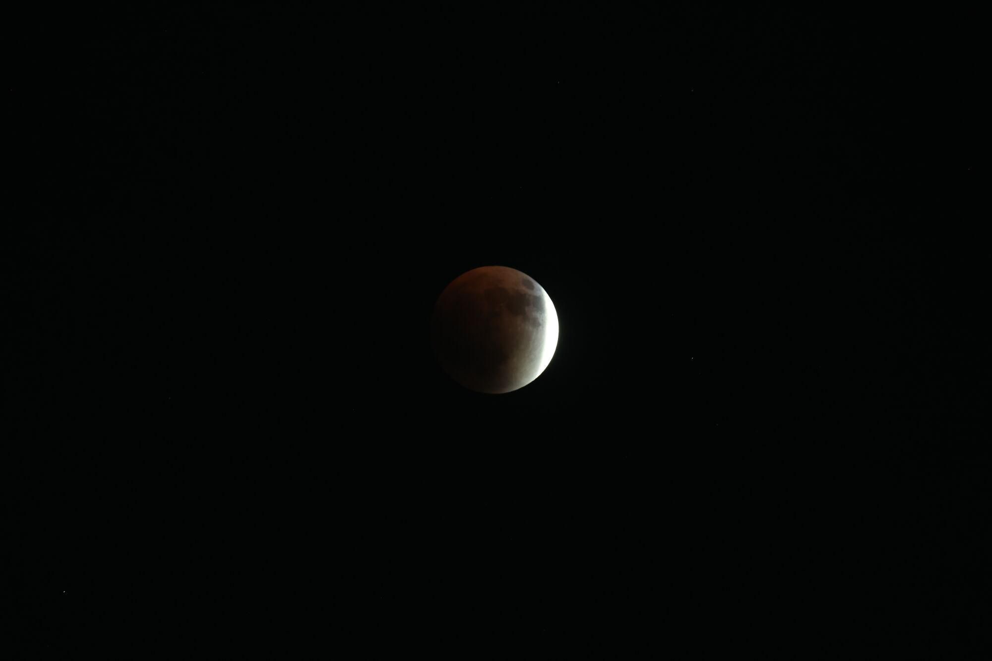 NABLUS (-), 07/09/2025.- The 'Blood Moon' is seen during a total lunar eclipse event visible from the suburbs of Nablus in the West Bank, 07 September 2025. Lunar eclipses, the opposite of solar eclipses, happen when the Earth is positioned between the full moon and sun. The red glow that is created earns these types of eclipses the title of 'blood moon.' EFE/EPA/ALAA BADARNEH