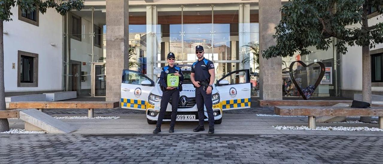 Los agentes Guacimara Martín y Juan Carlos Blanco, con el desfibrilador con el que salvaron la vida al trabajador.