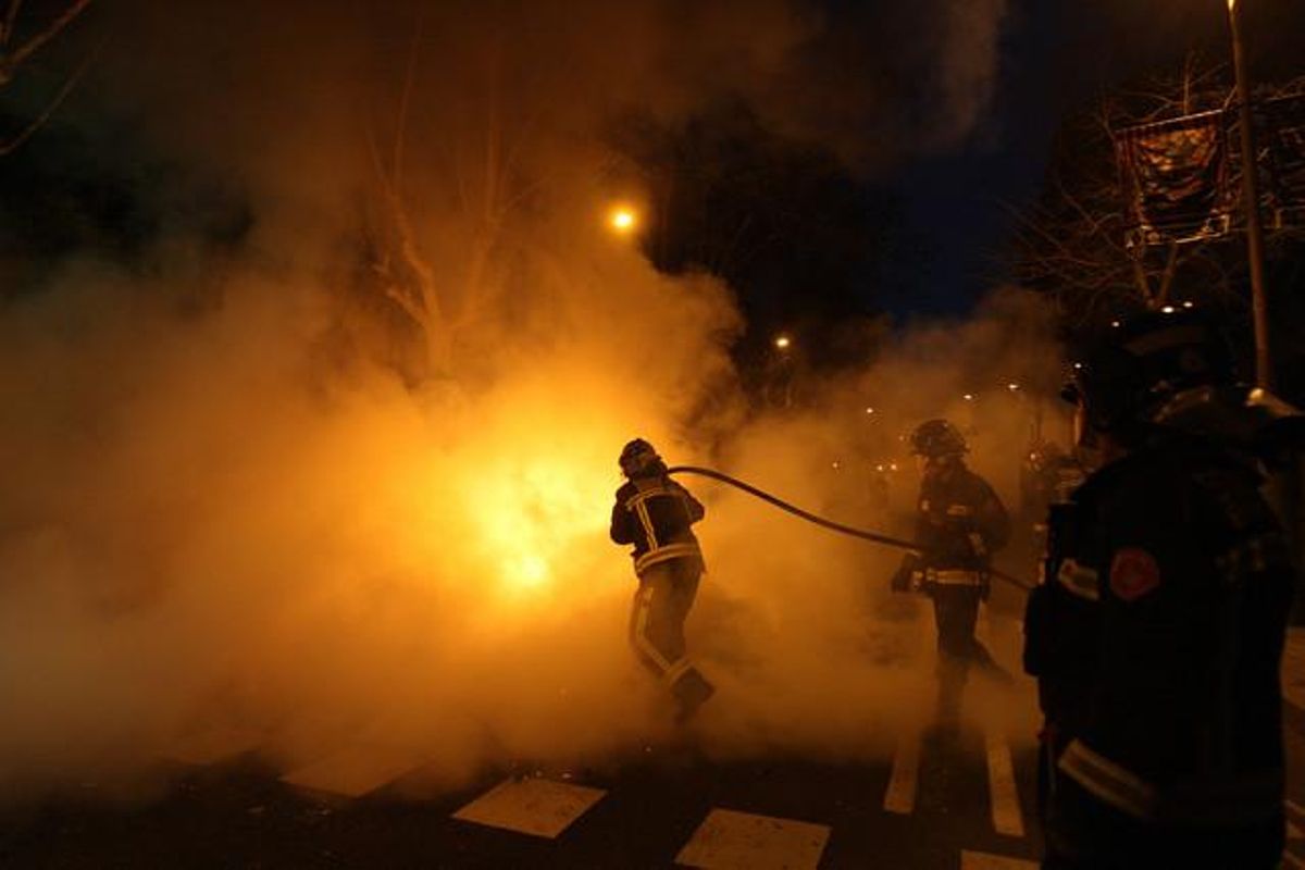 Bomberos apagando un fuego en una calle barcelonesa.