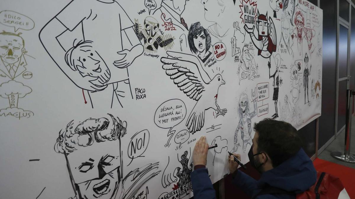 Mural solidario de diferentes artistas con el ‘No a la guerra’ en el Salón del Cómic, ayer. | J.M. LÓPEZ