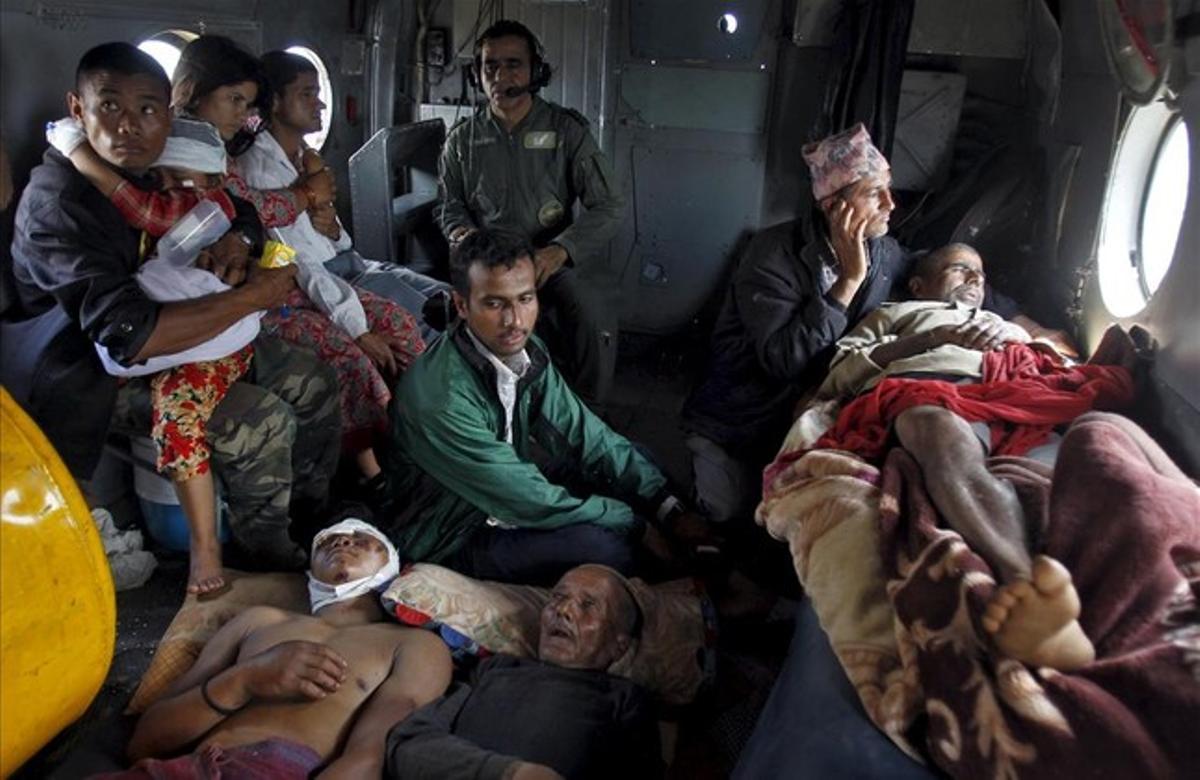 Víctimas del terremoto del sábado descansando dentro de un helicóptero de la Fuerza Aérea , a la espera de ser evacuados de Trishuli Bazar al aeropuerto en Katmandú.