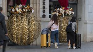 Dos turistas llegando a un hotel del paseo de Gràcia, en Barcelona.