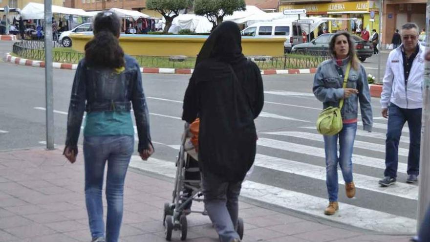 Una familia procedente de otro país (izquierda) pasea por la ciudad un jueves de mercadillo.