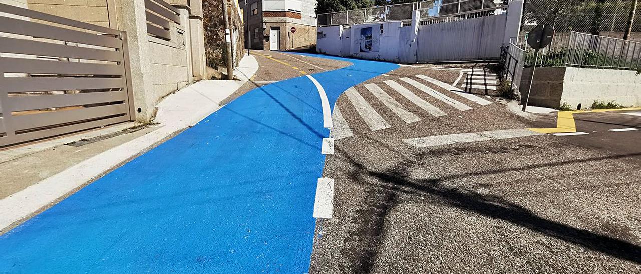 La senda azul del Camiño Real por delante de la entrada (a la derecha) a la Casa de la Virgen. |   // S.Á.