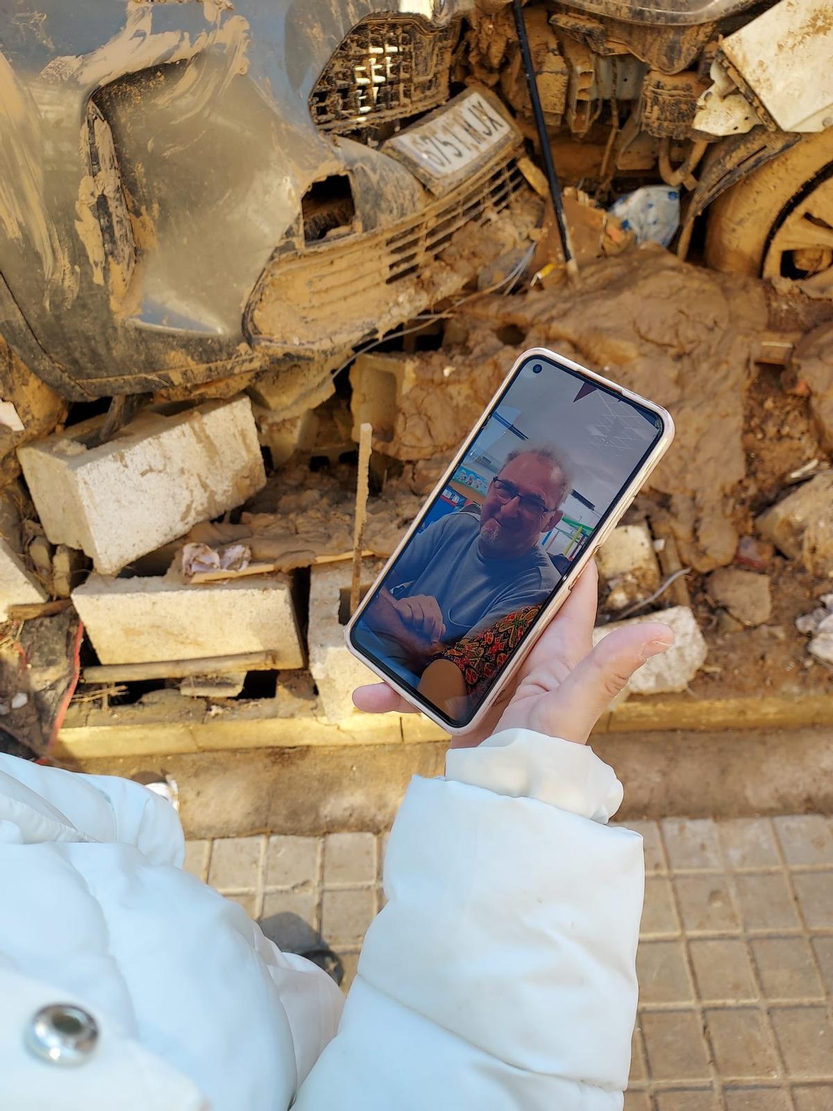 Meri García sostiene su móvil con la imagen que difundió de su padre por redes sociales.