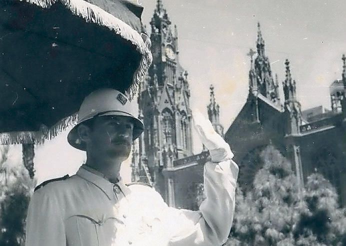 Un guardia municipal bajo la sombrilla para dirigir el tráfico frente a la iglesia de Arucas en los años 60.