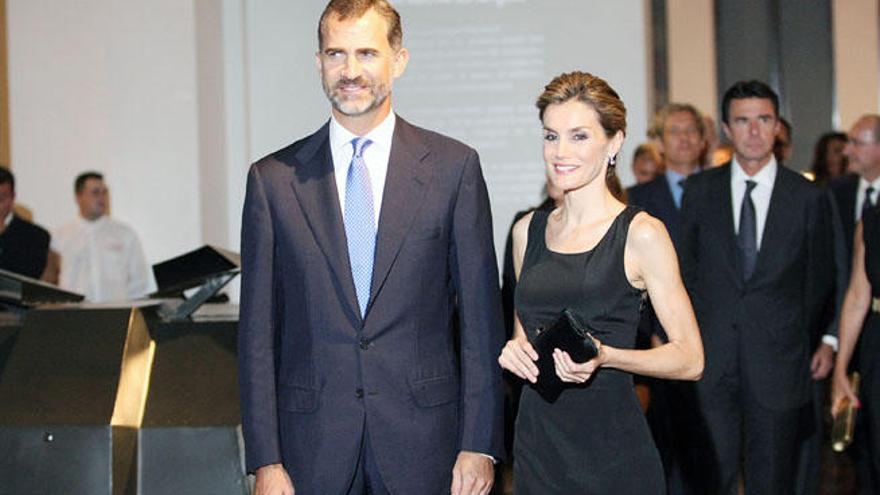 Don Felipe y Doña Letizia llegan al Museo del Automóvil, en Tabacalera. En la imagen central, se puede observar el escaso público que se acercó a recibirlos.