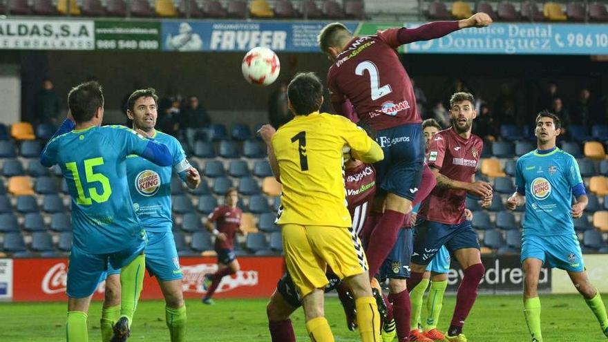 Goldar trata de cabecear el balón ante Monte en la acción del gol anulado al Pontevedra. // Rafa Vázquez