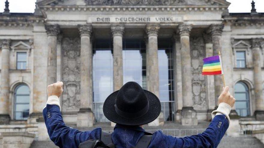 Un home celebra l&#039;aprovació del matrimoni homosexual davant la seu del Bundestag, a Berlín