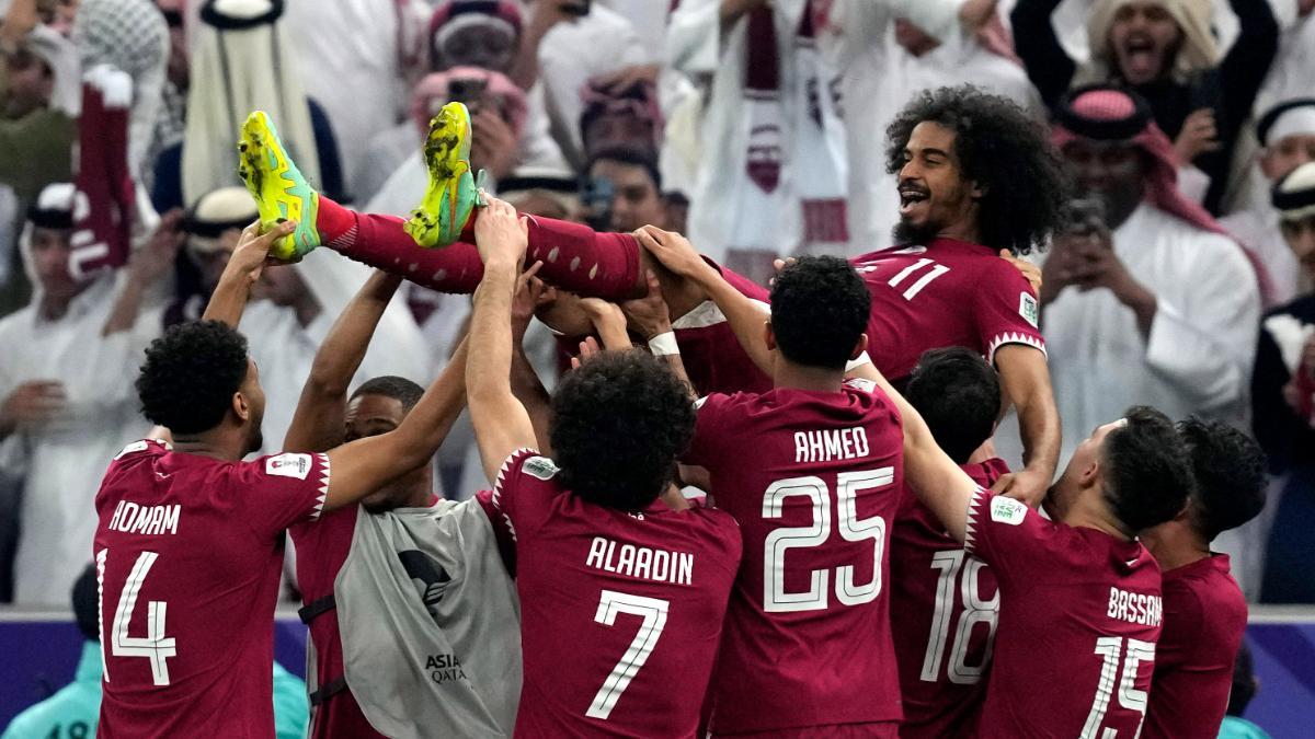 Qatar's players throw Akram Afif in the air as they celebrate Afif's three goals and their victory over Jordan in the Asian Cup final soccer match at the Lusail Stadium in Lusail, Qatar, Saturday, Feb. 10, 2024. (AP Photo/Thanassis Stavrakis)