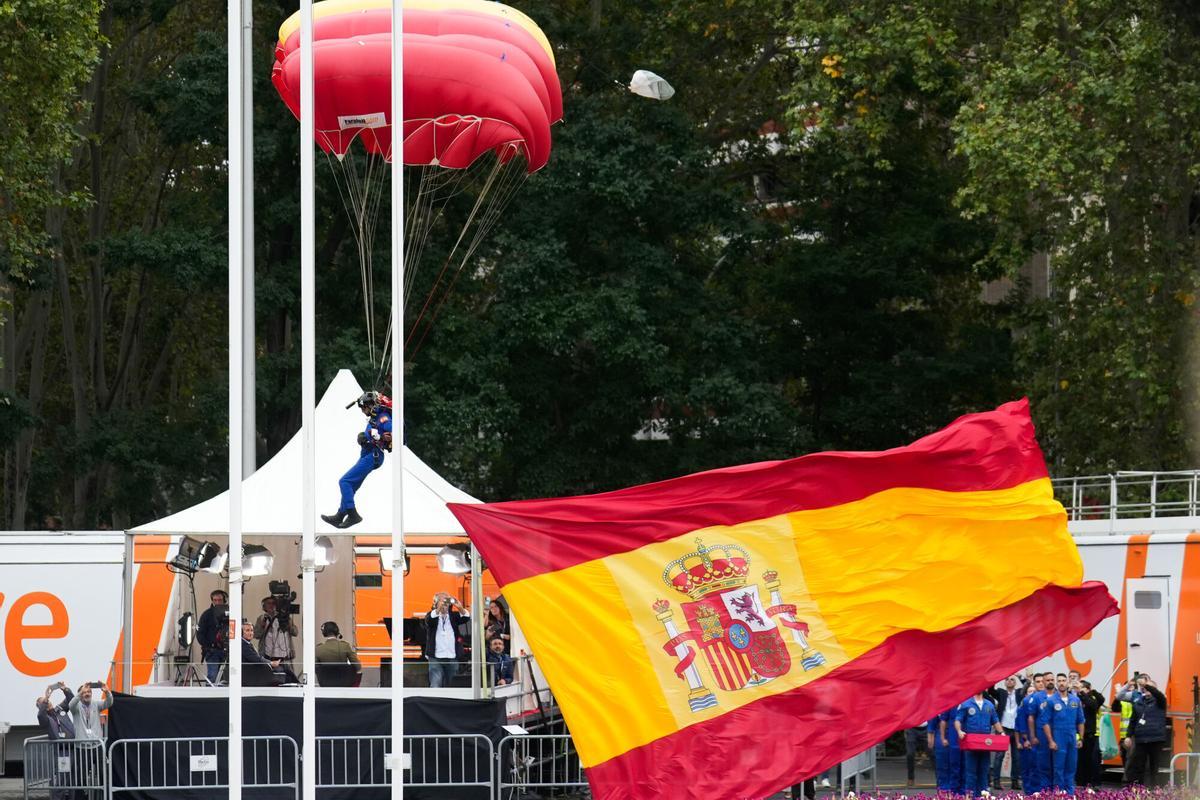 MADRID, 12/10/2025.- El sargento primero Óscar Marsal Hernández que porta la bandera de España al finalizar el salto paracaidista de la Patrulla Acrobática de Paracaidismo del Ejército del Aire y del Espacio, durante el desfile de las Fuerzas Armadas con motivo de la Fiesta Nacional este domingo en Madrid. EFE/Borja Sánchez-Trillo