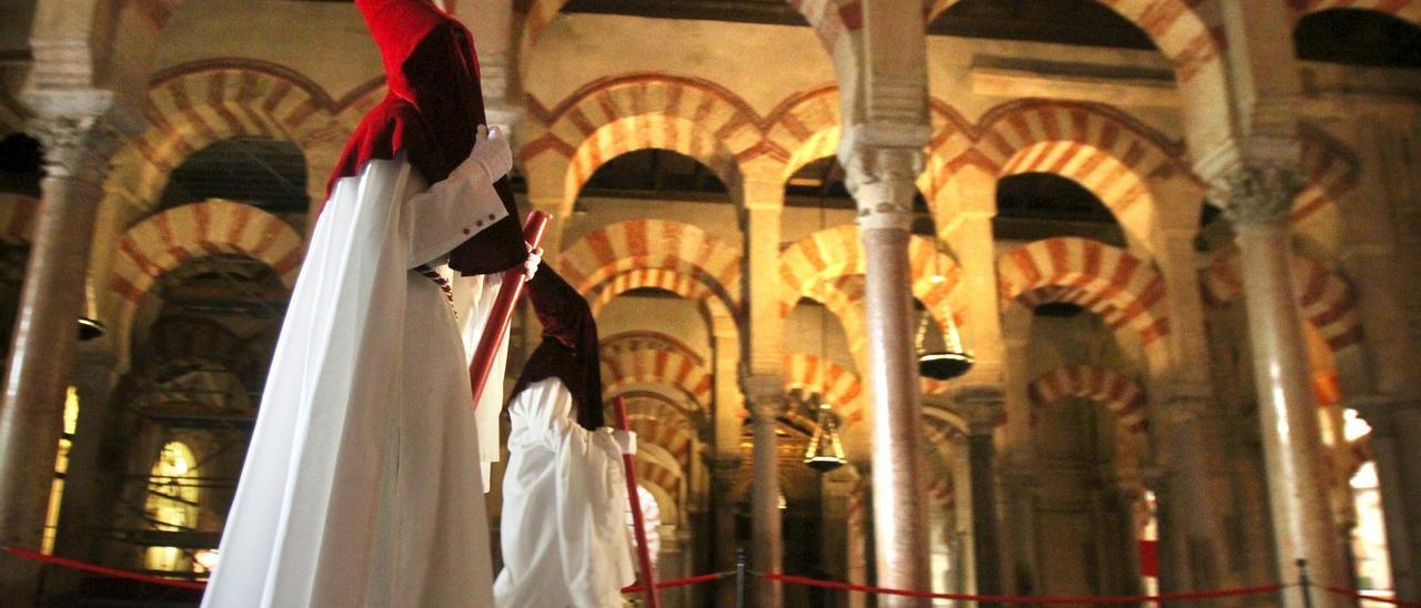 En el corazón de la Semana Santa. Unos nazarenos en el interior de la Mezquita de Córdoba.