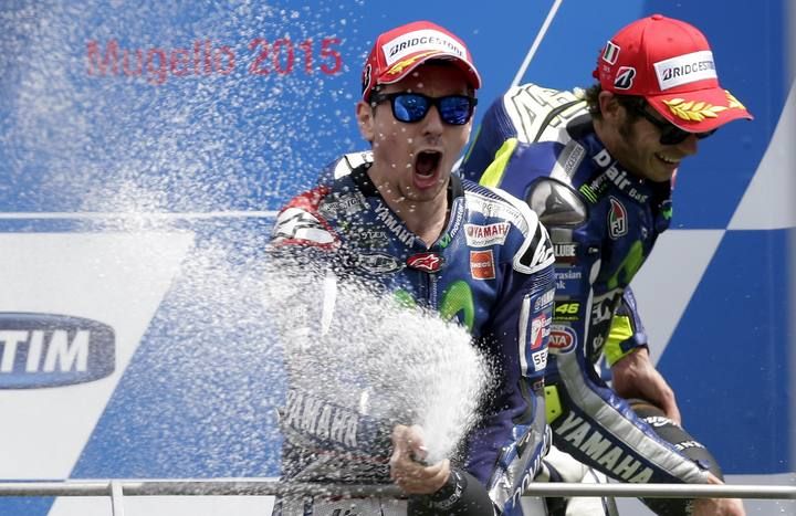 Yamaha MotoGP rider Lorenzo of Spain celebrates on the podium next to his team mate Rossi of Italy after the Italian Grand Prix at the Mugello circuit
