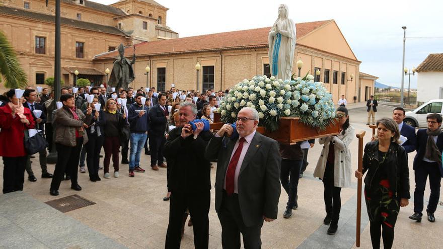 El presidente de la UCAM, junto a otros miembros de la Universidad, portando la imagen de la Virgen de Lourdes