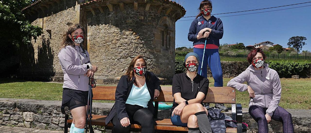 Por la izquierda, Patricia Terán, Elena Gómez, Elena Llanes, Eva Rodríguez y Estefanía Rodero, junto a la iglesia de San Miguel de Dueñas, en la parroquia de Castiello de Bernueces, durante una de sus rutas.