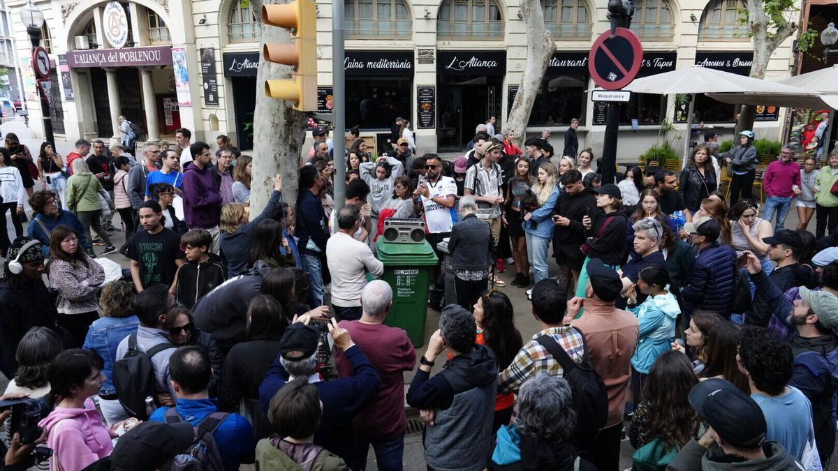 Vecinos de Poblenou se reúnen en la rambla a escuchar en la radio al presidente Pedro Sánchez